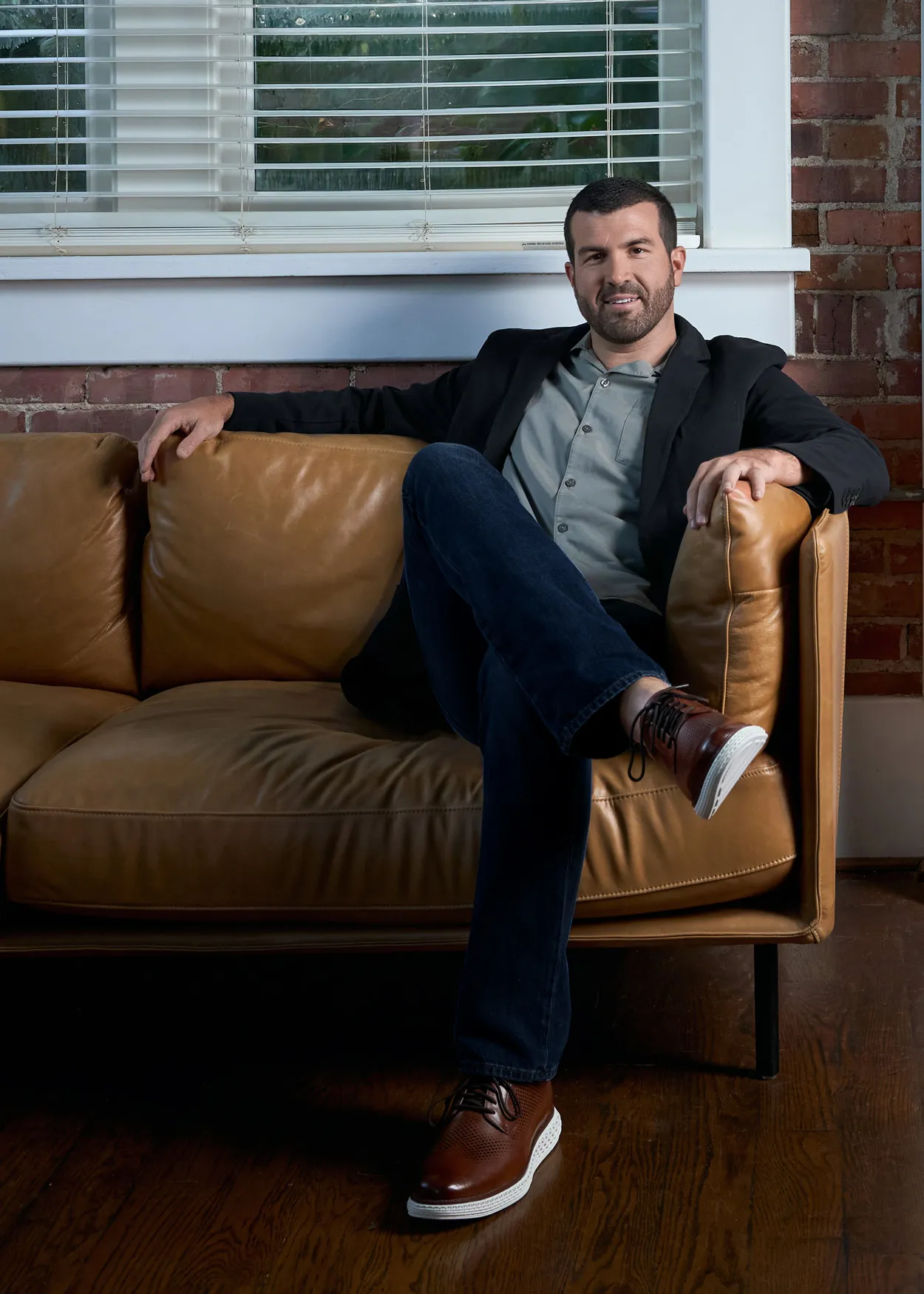 Chris Wendel seated on a leather sofa in his Little Rock office.